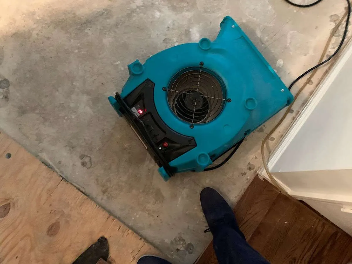 Air mover drying subfloor during Leak Detection & Repair in Lockport